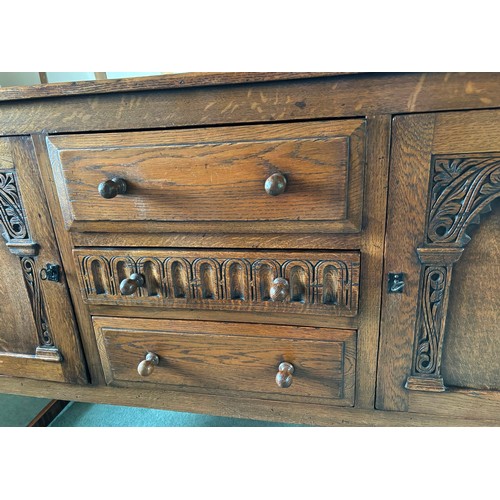 9231 - A1920's oak sideboard with 2 hinged doors with wooden knob handles, sitting either side of 3 central... 