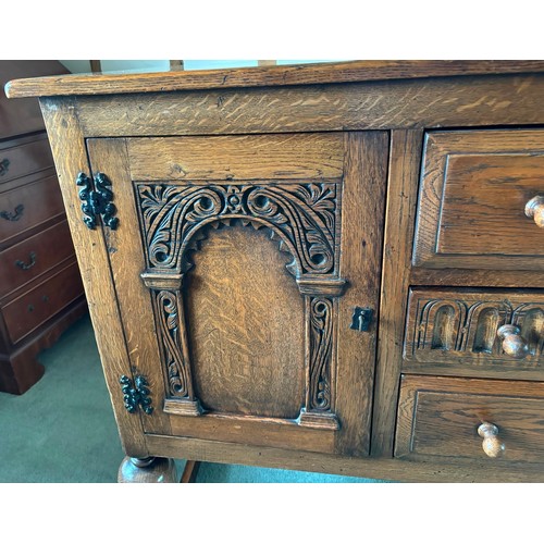 9231 - A1920's oak sideboard with 2 hinged doors with wooden knob handles, sitting either side of 3 central... 