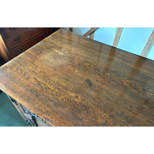 9231 - A1920's oak sideboard with 2 hinged doors with wooden knob handles, sitting either side of 3 central... 