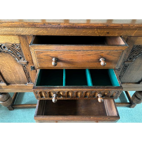 9231 - A1920's oak sideboard with 2 hinged doors with wooden knob handles, sitting either side of 3 central... 