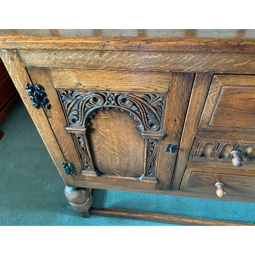 9231 - A1920's oak sideboard with 2 hinged doors with wooden knob handles, sitting either side of 3 central... 