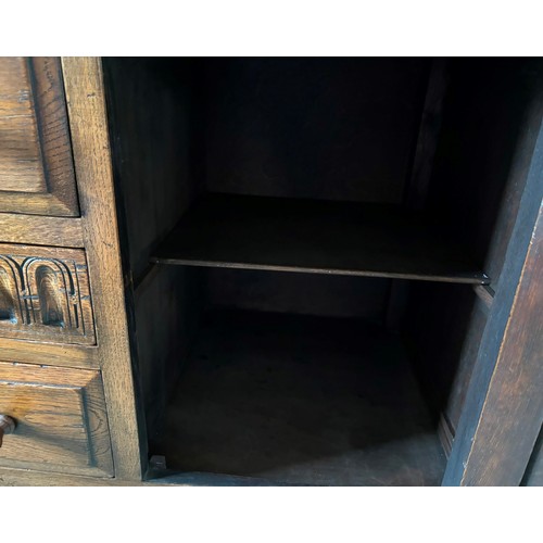 9231 - A1920's oak sideboard with 2 hinged doors with wooden knob handles, sitting either side of 3 central... 