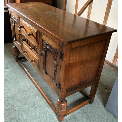 9231 - A1920's oak sideboard with 2 hinged doors with wooden knob handles, sitting either side of 3 central... 