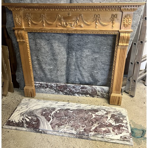 9192 - A pine fireplace with red and white marble base, raised urn, swag, ribbon and reeded decoration, fir... 