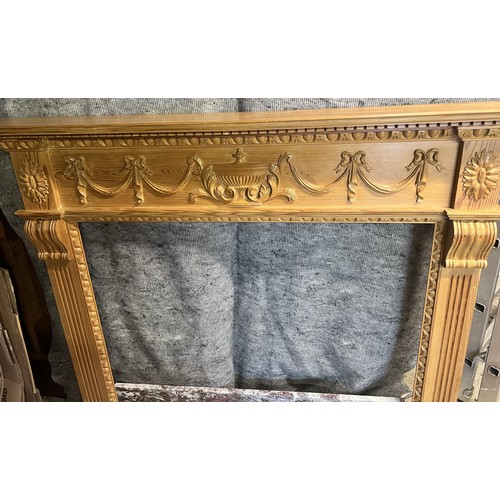 9192 - A pine fireplace with red and white marble base, raised urn, swag, ribbon and reeded decoration, fir... 