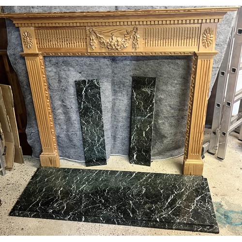 9193 - A pine fireplace with green marble base, raised carved floral, swag and reeded decoration, fireplace... 