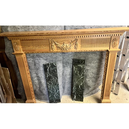 9193 - A pine fireplace with green marble base, raised carved floral, swag and reeded decoration, fireplace... 