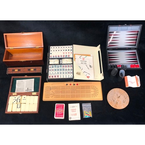 9212 - A plastic Mah-Jong set (boxed), a set of dominoes (boxed), a backgammon set (boxed), 3 various cribb... 