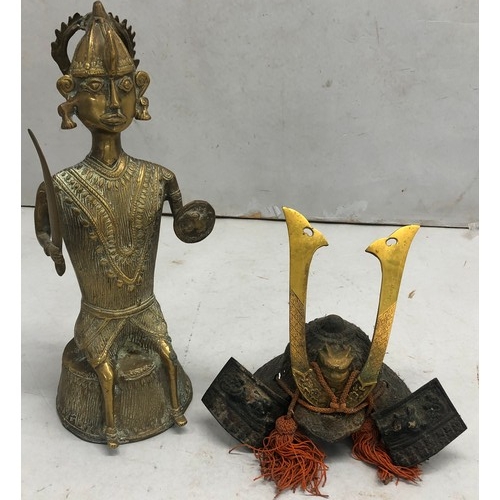 9238 - An Eastern heavy brass figure of a seated warrior, 35cm high and a metal figure of an Oriental hat i... 