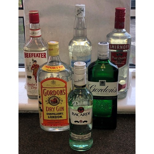 9166 - 3 bottles of gin, Beefeater, Gordons and Gordons Dry, 1 bottle of Smirnoff, a bottle of white rum an... 