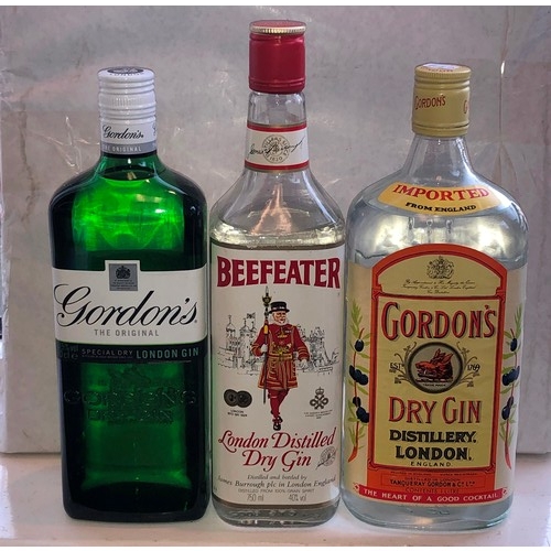 9166 - 3 bottles of gin, Beefeater, Gordons and Gordons Dry, 1 bottle of Smirnoff, a bottle of white rum an... 