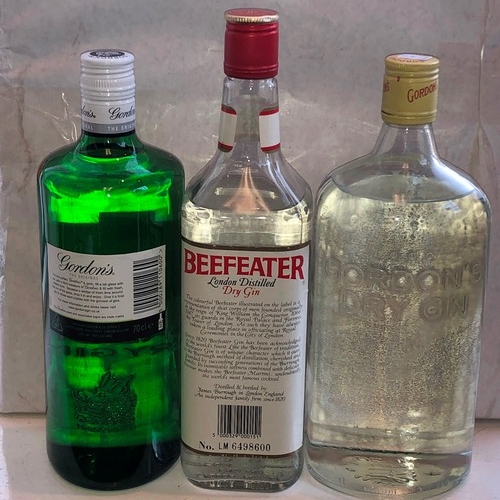 9166 - 3 bottles of gin, Beefeater, Gordons and Gordons Dry, 1 bottle of Smirnoff, a bottle of white rum an... 