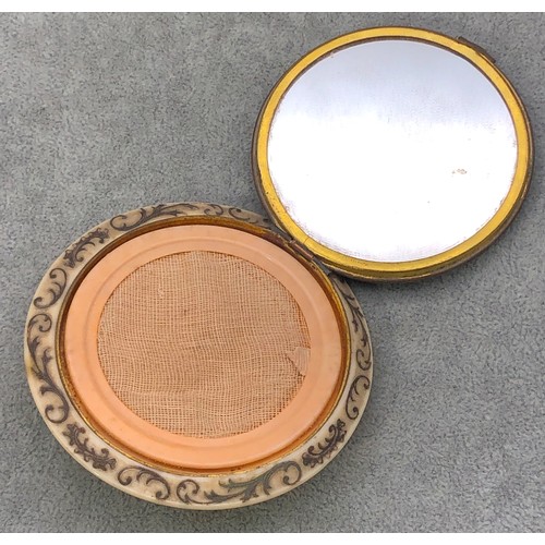 9249 - A circular Bakelite round powder compact with figure decoration, 8.5cm diameter