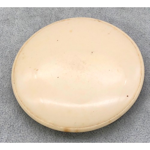 9249 - A circular Bakelite round powder compact with figure decoration, 8.5cm diameter