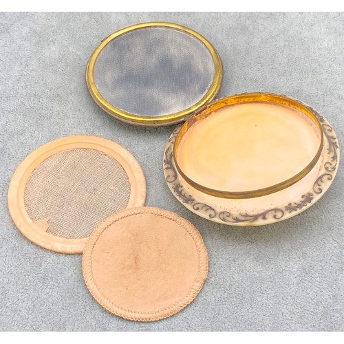 9249 - A circular Bakelite round powder compact with figure decoration, 8.5cm diameter