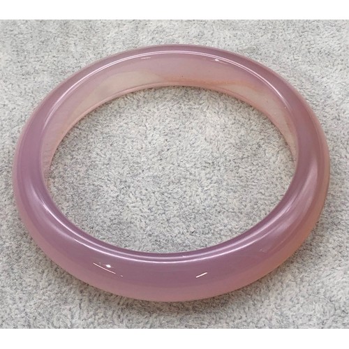 9250 - A pink jade style bangle, 8cm diameter