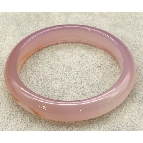 9250 - A pink jade style bangle, 8cm diameter