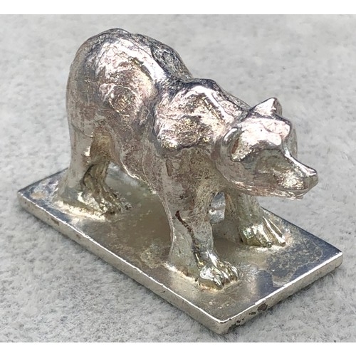 9257 - A small silver coloured metal model of a standing bear (marks rubbed), 4cm long, 57 grams