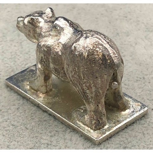 9257 - A small silver coloured metal model of a standing bear (marks rubbed), 4cm long, 57 grams