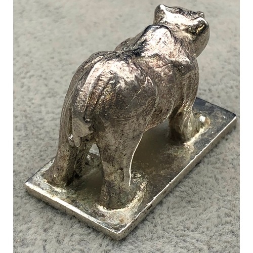 9257 - A small silver coloured metal model of a standing bear (marks rubbed), 4cm long, 57 grams