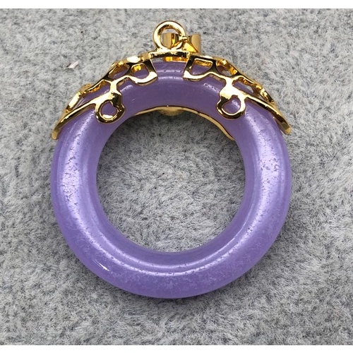 9264 - A lavender and green jade style circular pendant, 4cm high