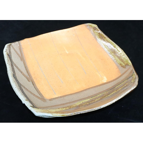 1 - A glazed Slipware square Studio pottery dish by Ruthanne Tudball (b. 1948) on 3 splayed feet, indist... 