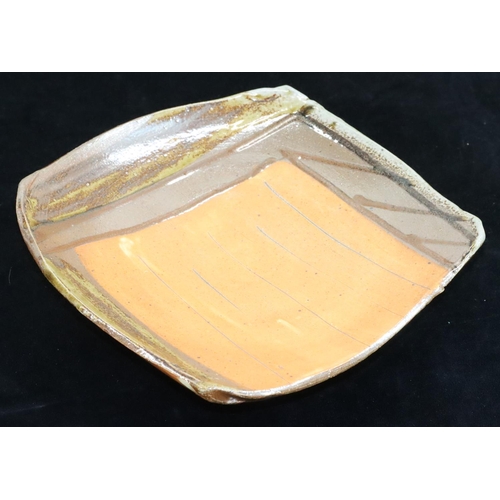 1 - A glazed Slipware square Studio pottery dish by Ruthanne Tudball (b. 1948) on 3 splayed feet, indist... 