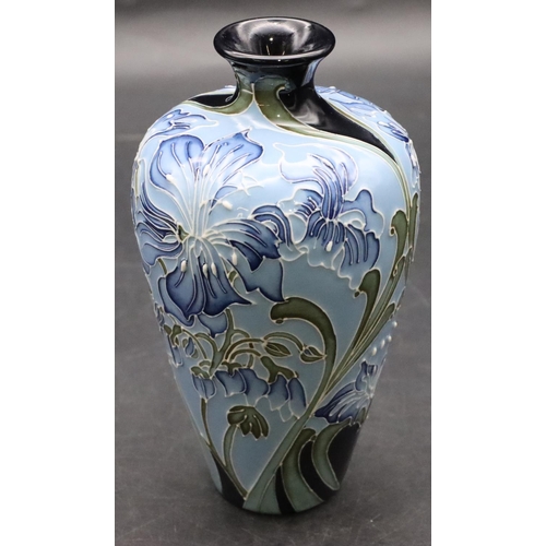 11 - A modern Moorcroft small round bulbous thin necked vase on pale blue ground with allover floral and ... 