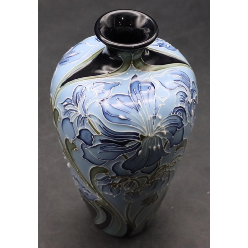 11 - A modern Moorcroft small round bulbous thin necked vase on pale blue ground with allover floral and ... 