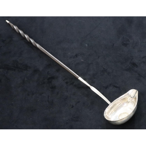 138 - A Georgian silver coloured metal toddy ladle set with 18th Century silver coin with twist bone handl... 