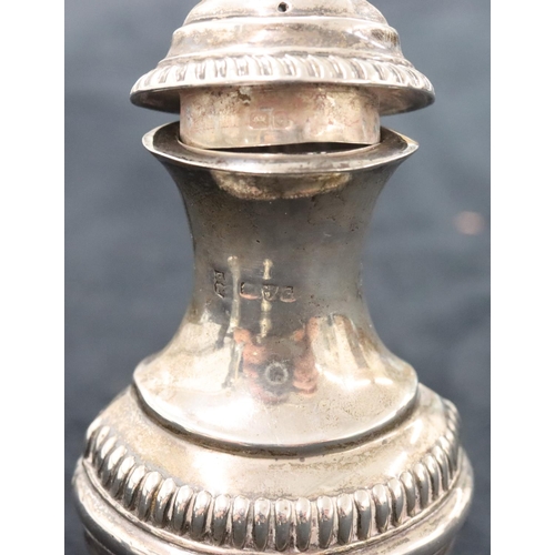 139 - A George III silver bulbous shaped pepperette with embossed swag, floral and reeded decoration, on r... 