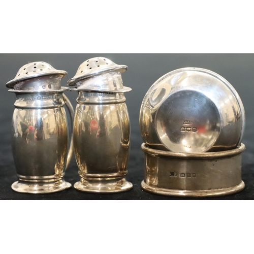 142 - A pair of Birmingham silver round bulbous shaped pepper pots, another Birmingham silver round pepper... 