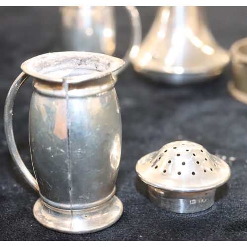 142 - A pair of Birmingham silver round bulbous shaped pepper pots, another Birmingham silver round pepper... 