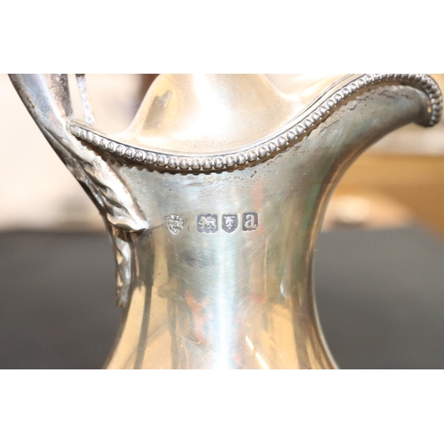 145 - A late Victorian silver round bulbous thin necked water jug with hinged lid and ebonised handle and ... 