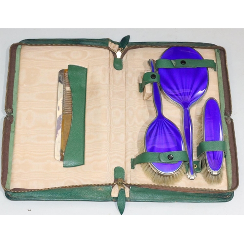 152 - A George V silver and blue enamelled 4-piece dressing table set, comprising of hand mirror, 2 brushe... 