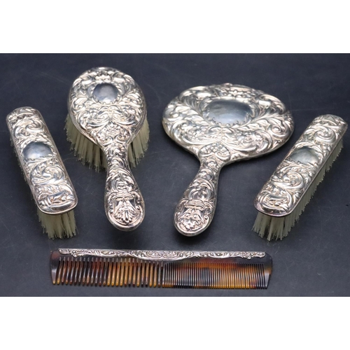 169 - A Birmingham silver 5-piece dressing set with allover embossed figurehead, floral and scroll decorat... 