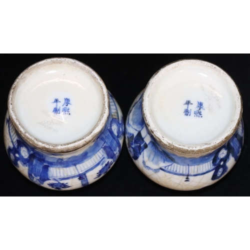 18 - A pair of Oriental small round bulbous thin necked lidded ginger jars with figure and landscape deco... 