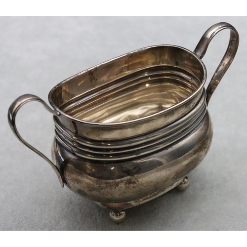 180 - A London silver rectangular bulbous shaped 2-handled sugar bowl on ball feet, 4.2oz