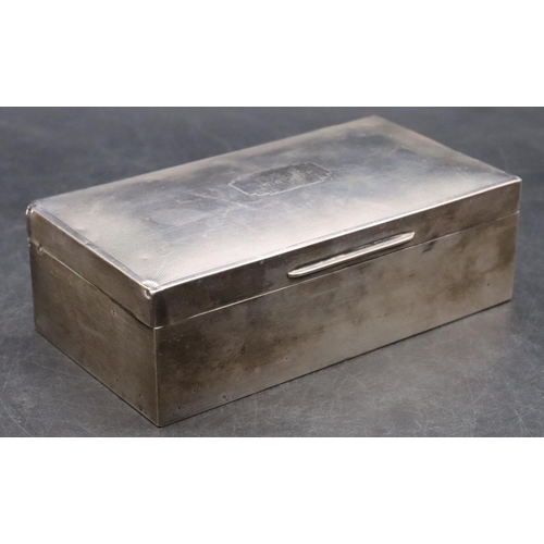 191 - A Birmingham silver rectangular shaped cigarette box with engine turned hinged domed lid enclosing c... 