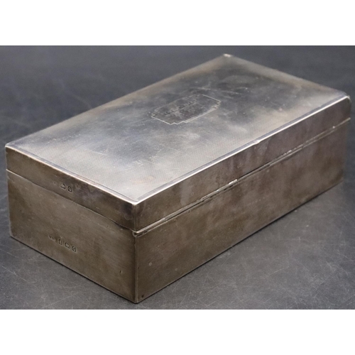 191 - A Birmingham silver rectangular shaped cigarette box with engine turned hinged domed lid enclosing c... 