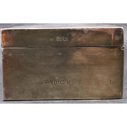 191 - A Birmingham silver rectangular shaped cigarette box with engine turned hinged domed lid enclosing c... 