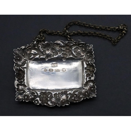 200 - A 19th Century silver wine label with embossed grape and vine decoration, with chain 