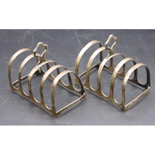 227 - A pair of Warner Brothers Anglo Indian silver coloured metal 5-bar toast racks, 7.8cm wide, 2.8oz