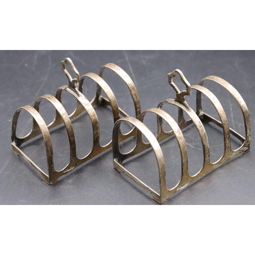 227 - A pair of Warner Brothers Anglo Indian silver coloured metal 5-bar toast racks, 7.8cm wide, 2.8oz