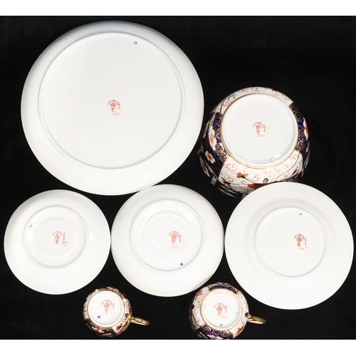 23 - A Royal Crown Derby Imari pattern tea service, comprising of slop bowl, pair of cake plates, 10 cups... 