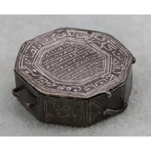 231 - A small Eastern octagonal shaped 2-handled snuff box with allover engraved decoration and hinged lid... 