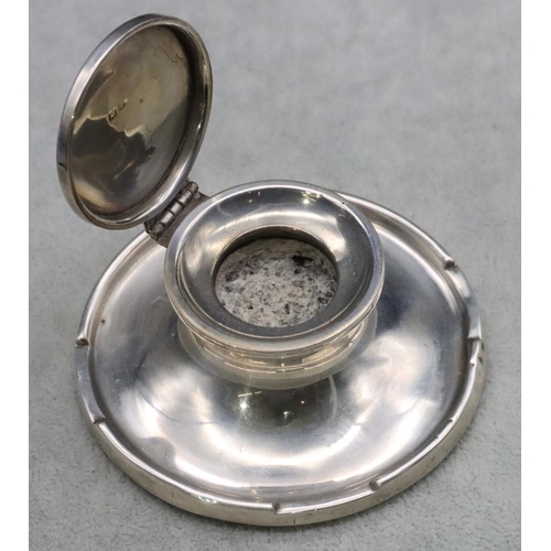 235 - A Birmingham silver round inkwell with hinged lid and sweeping base, 9cm diameter