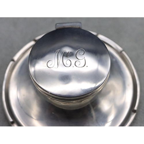 235 - A Birmingham silver round inkwell with hinged lid and sweeping base, 9cm diameter