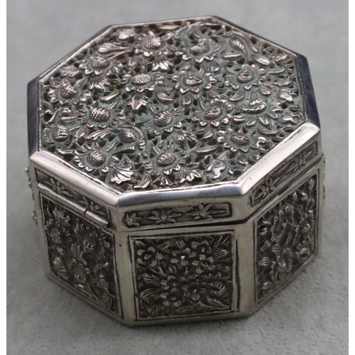 237 - An Oriental silver coloured metal octagonal shaped pierced box with embossed floral and leaf decorat... 