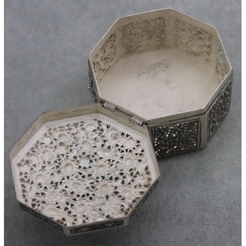 237 - An Oriental silver coloured metal octagonal shaped pierced box with embossed floral and leaf decorat... 